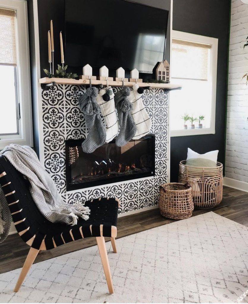 monochrome interior design for christmas 2020 with risom lounge chair, rattan baskets, inserted fireplace and faded distressed area rug - padstyle.com