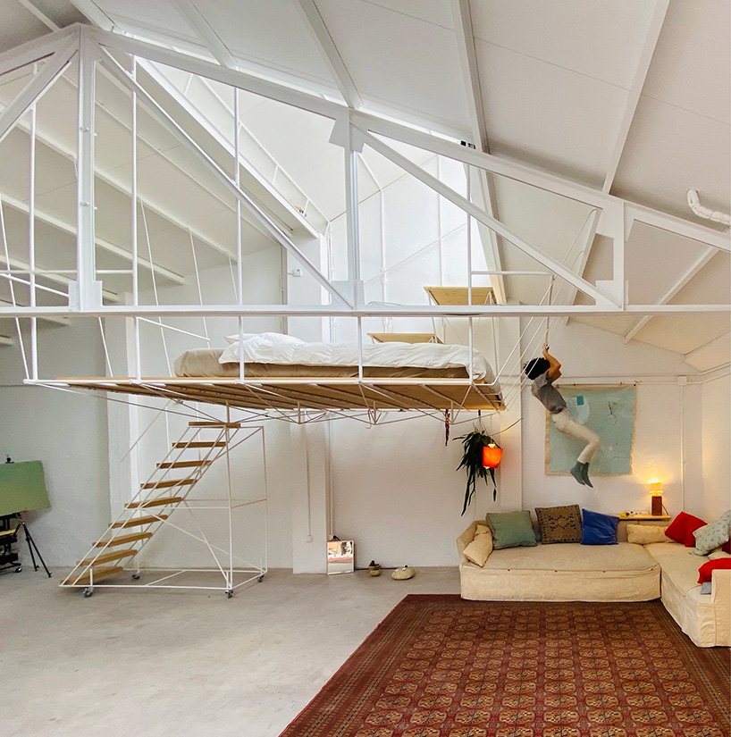 pía mendaro-designed artist's studio in madrid has a bed suspended from its ceiling