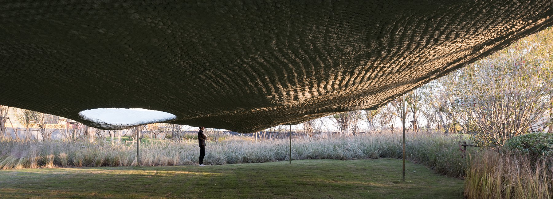 the undulating 'soft matter' pavilion takes inspiration from its site's unnatural geology